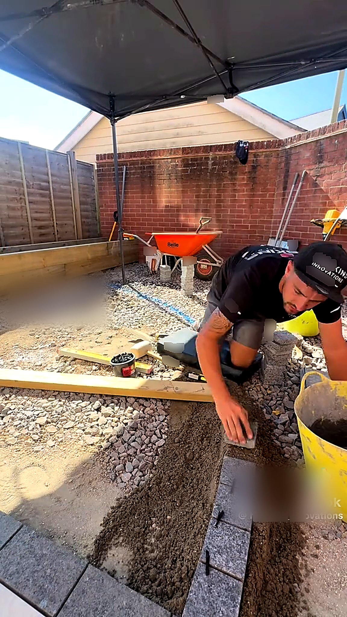 Granite setts being bedded on mortar to form a curved edge