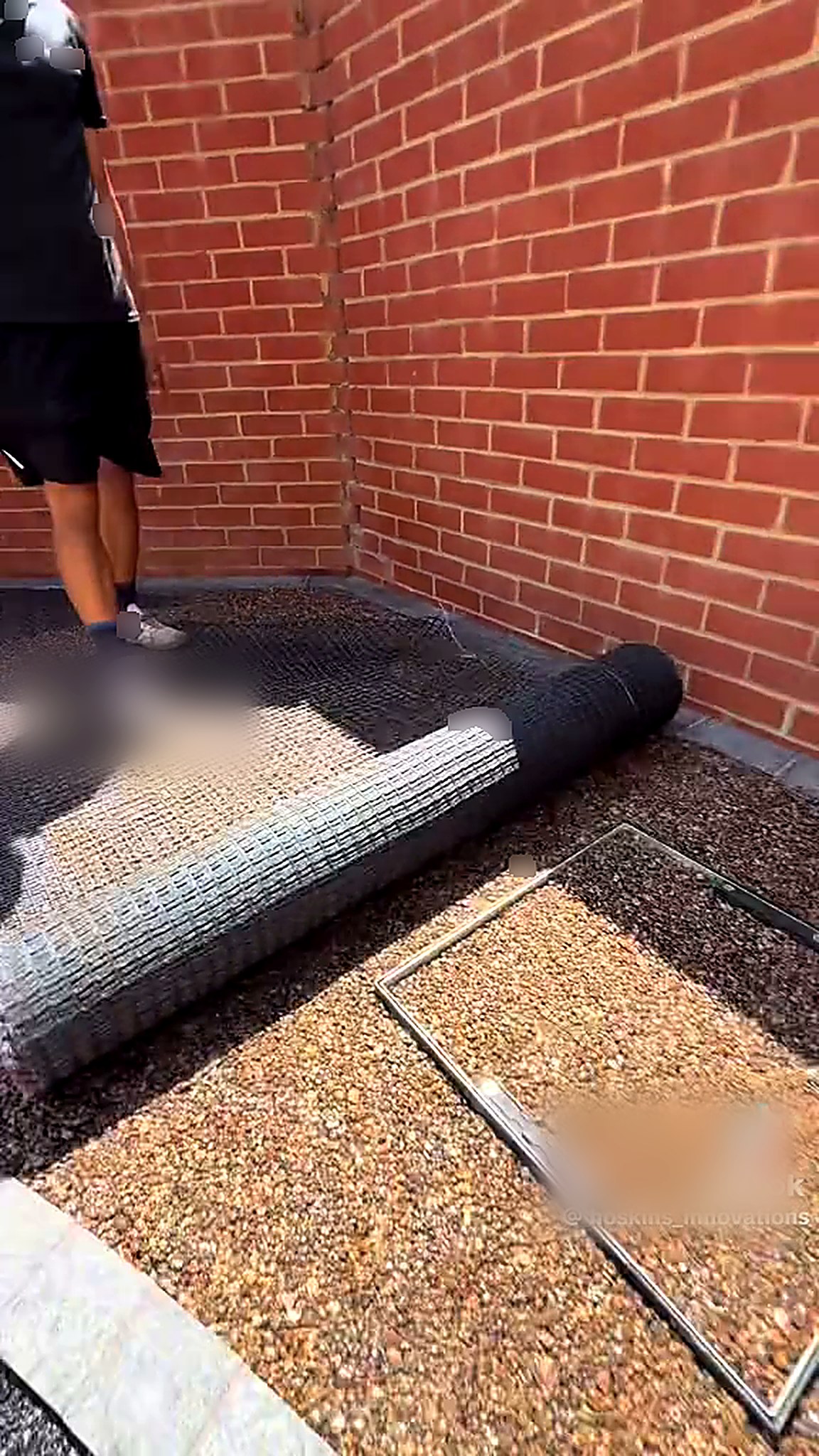 Geogrid and membrane rolled out over a prepared sub-base