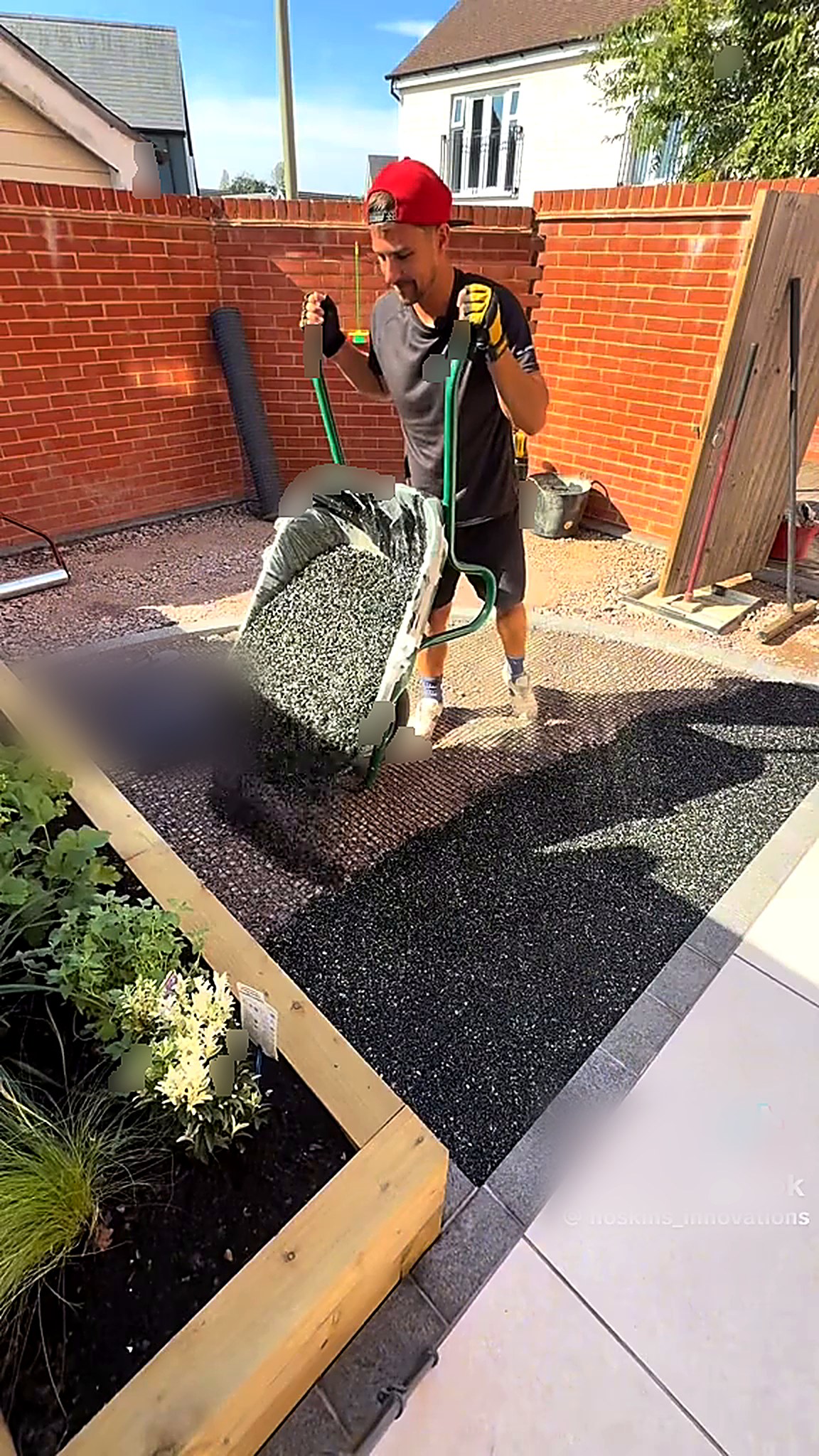 Resin bound aggregate being barrowed into a courtyard garden