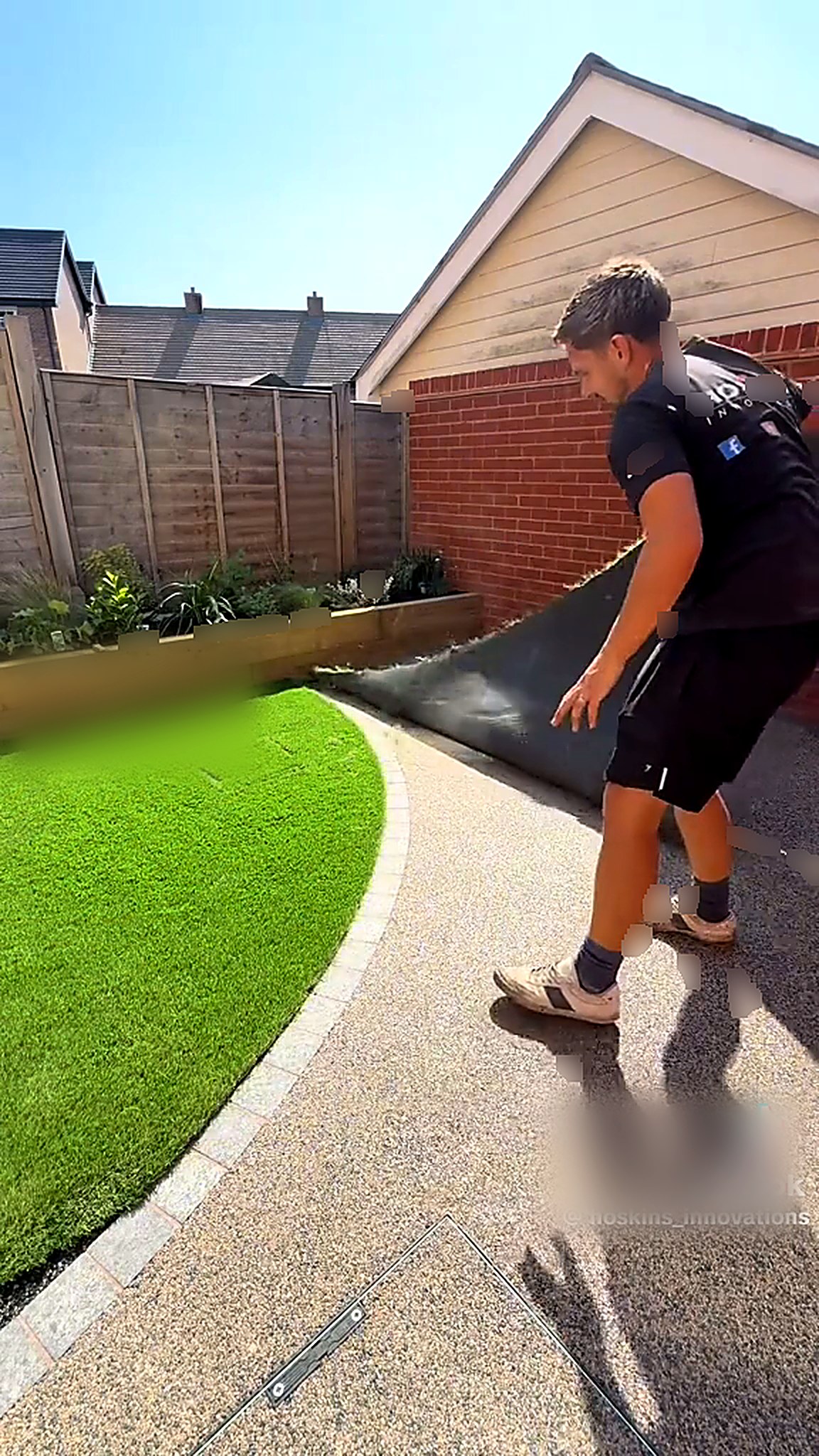 Artificial lawn being laid to a curved granite sett edge