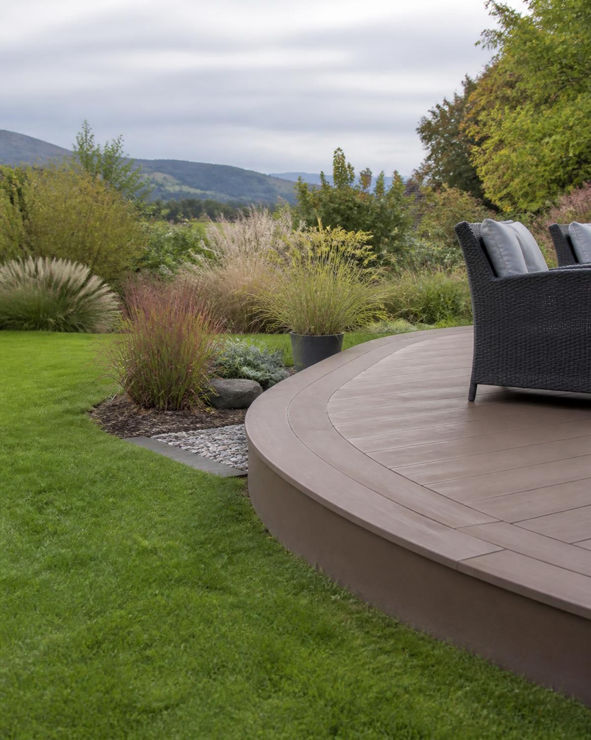 Professionally formed curved composite decking edge in a landscaped Lake District garden