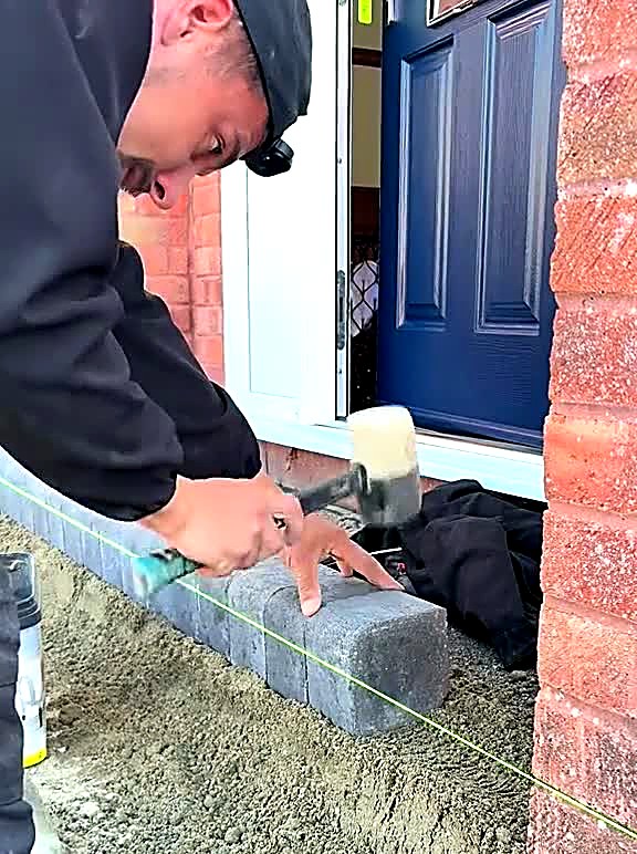Clean sub-base stone tipped into an excavated driveway