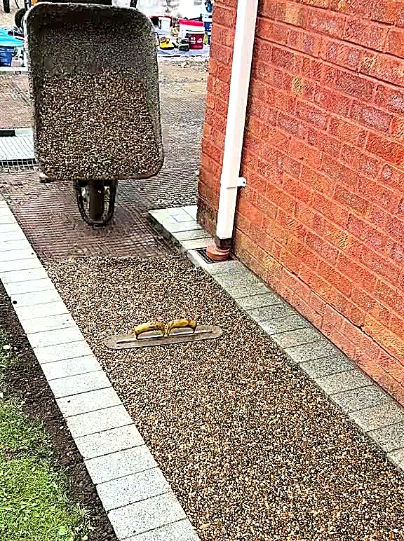 Golden resin bound aggregate barrowed onto a prepared entrance path