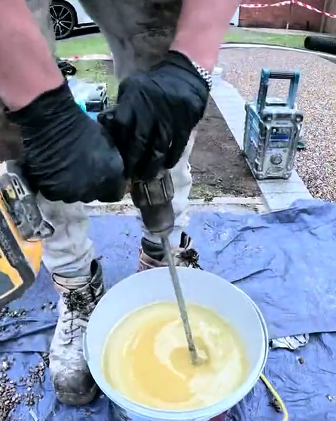 Resin binder being mixed on site with a paddle mixer before the aggregate is added