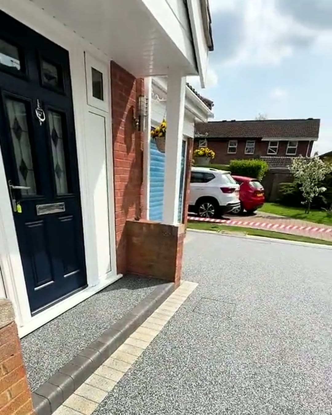 Finished resin driveway running flush to the front door of a family home