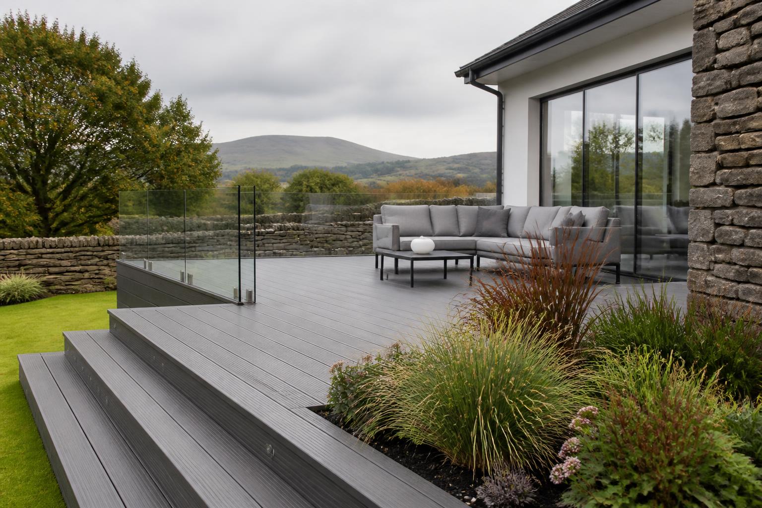 Grey composite decking terrace in a Cumbrian garden in daylight