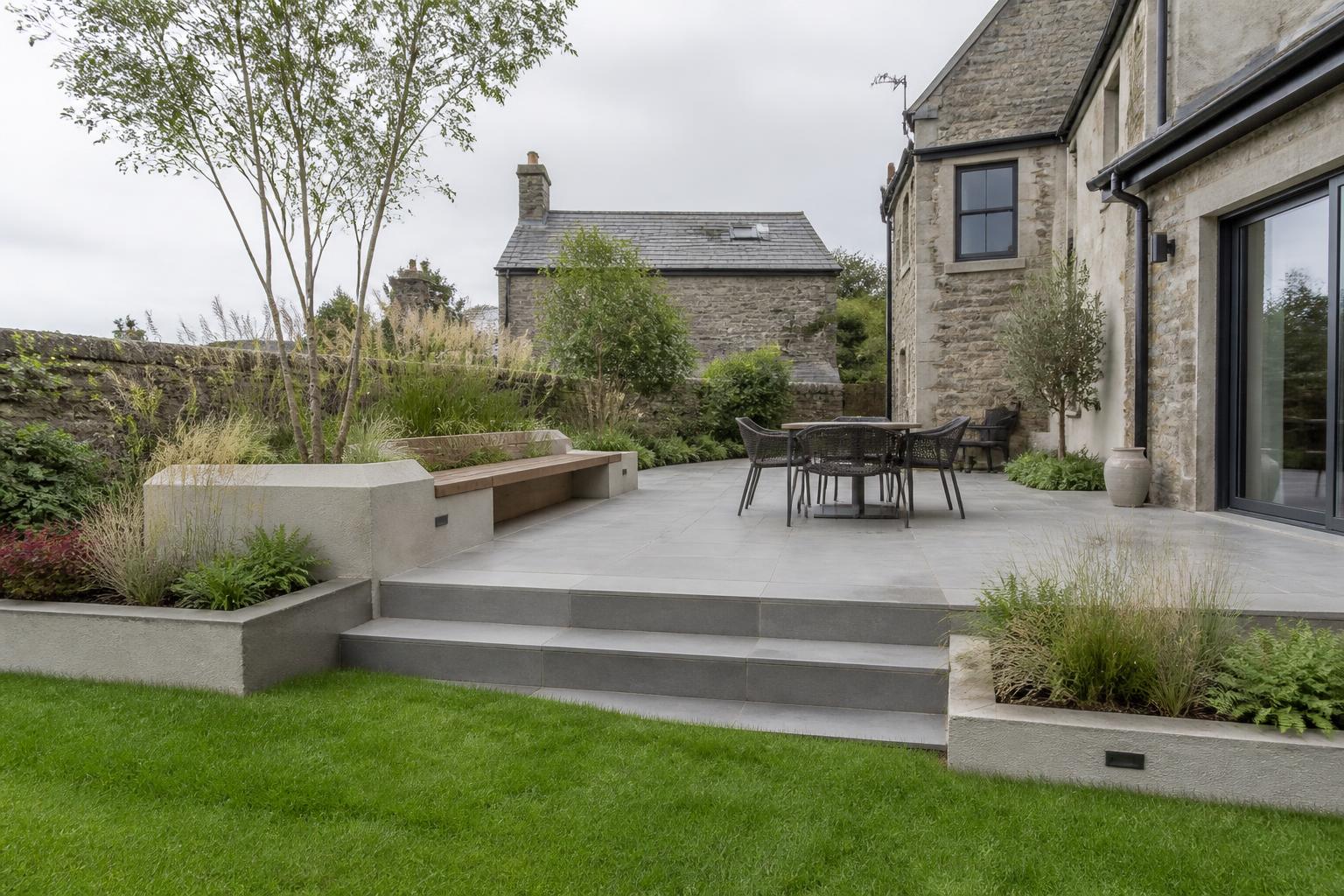 Porcelain patio terrace beside a Cumbrian stone house in daylight