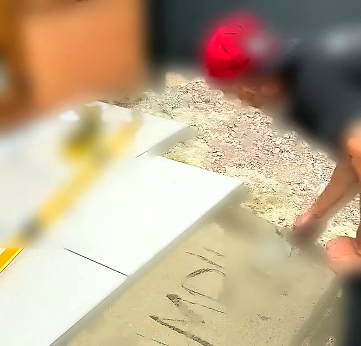 Installer setting out levels across the prepared mortar bed