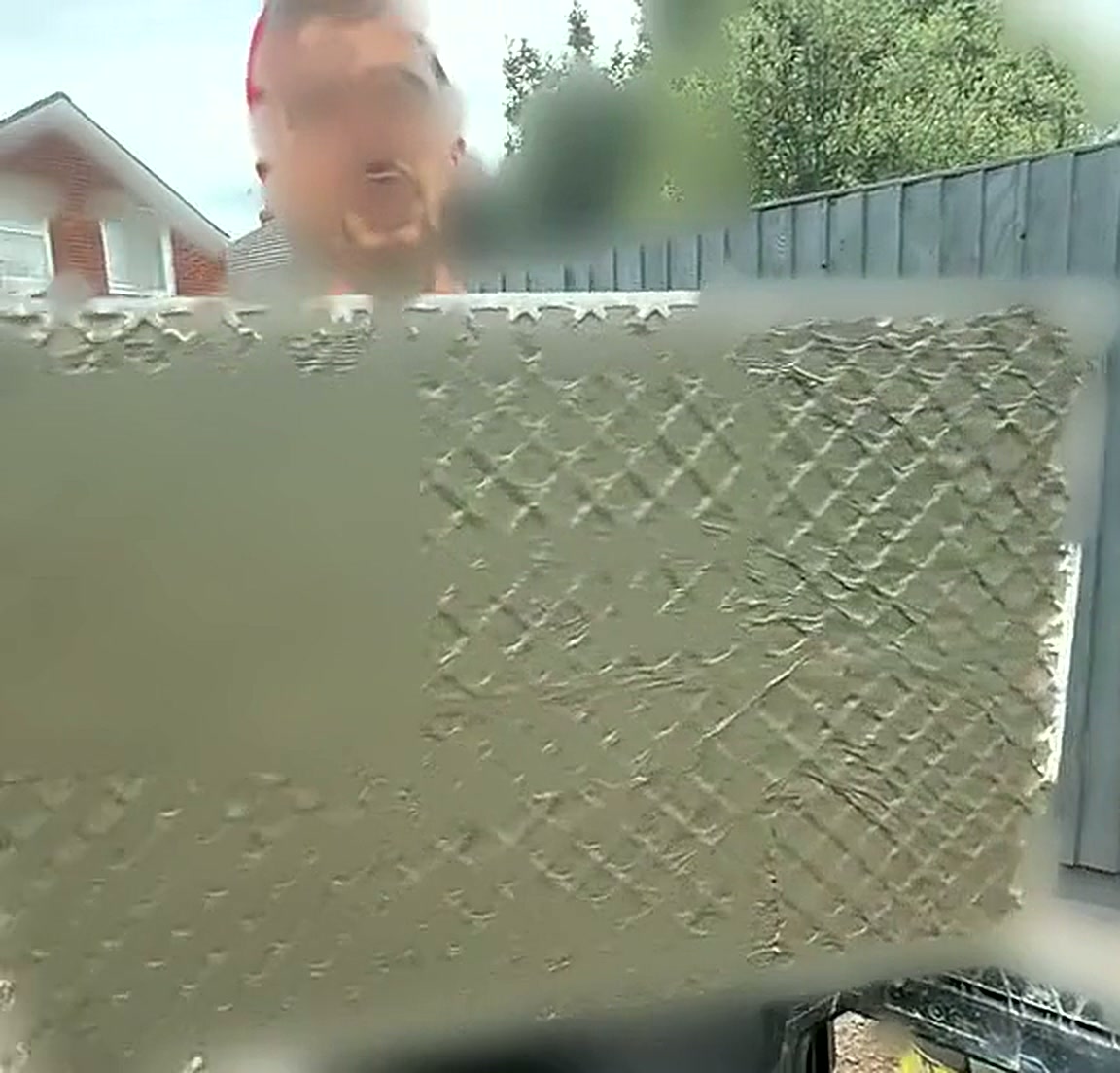 Installer lifting a large porcelain slab into position